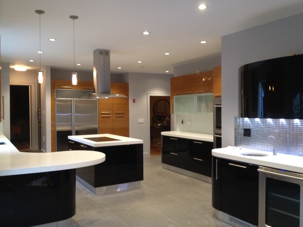 Medium sized classic u-shaped kitchen/diner in Boston with a submerged sink, flat-panel cabinets, brown cabinets, engineered stone countertops, white splashback, glass tiled splashback, stainless steel appliances, ceramic flooring and multiple islands.