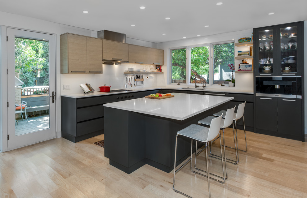 Large trendy l-shaped light wood floor and beige floor kitchen photo in Denver with an undermount sink, flat-panel cabinets, quartz countertops, white backsplash, porcelain backsplash, paneled appliances, an island, white countertops and gray cabinets