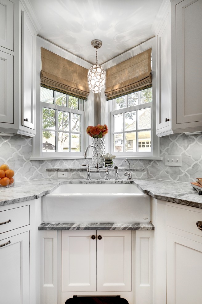 Example of a transitional kitchen design in Minneapolis with a farmhouse sink, recessed-panel cabinets, white cabinets, gray backsplash and marble backsplash
