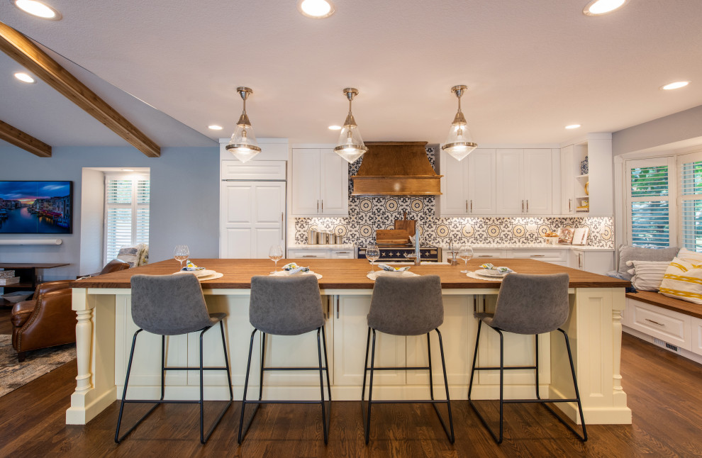 Inspiration for a mid-sized transitional l-shaped dark wood floor enclosed kitchen remodel in Denver with a farmhouse sink, raised-panel cabinets, yellow cabinets, wood countertops, multicolored backsplash, porcelain backsplash, colored appliances, an island and brown countertops
