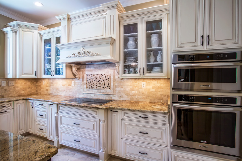 Inspiration for a mid-sized timeless u-shaped marble floor kitchen remodel in Richmond with a double-bowl sink, raised-panel cabinets, beige cabinets, granite countertops, beige backsplash, stone tile backsplash, stainless steel appliances and an island