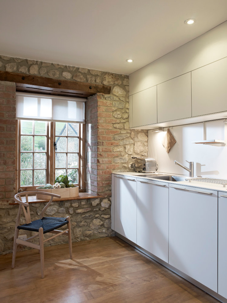 This is an example of a small rustic kitchen in Devon.