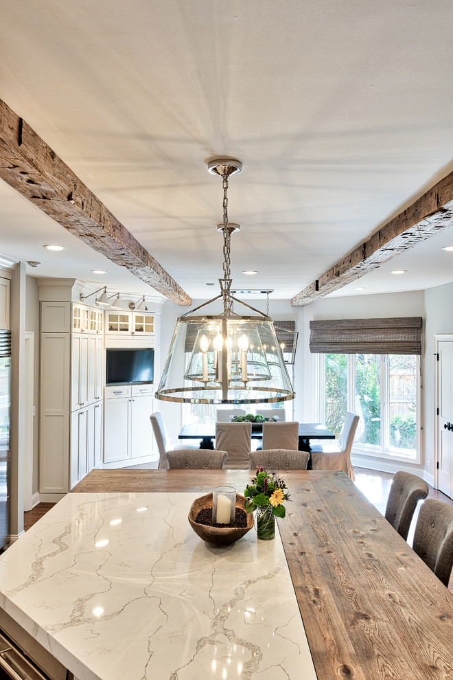 Eat-in kitchen - large farmhouse u-shaped dark wood floor and brown floor eat-in kitchen idea in Nashville with a double-bowl sink, shaker cabinets, white cabinets, marble countertops, white backsplash, subway tile backsplash, stainless steel appliances and an island