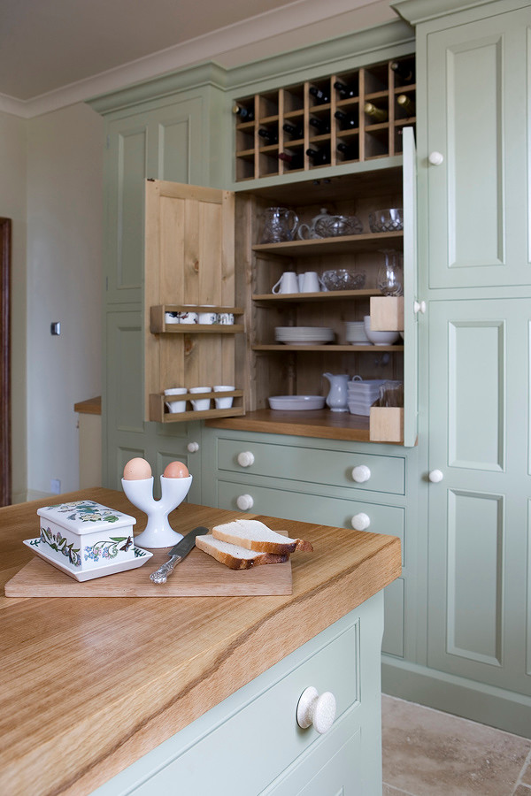 Kitchen - country kitchen idea in Other with beaded inset cabinets and wood countertops