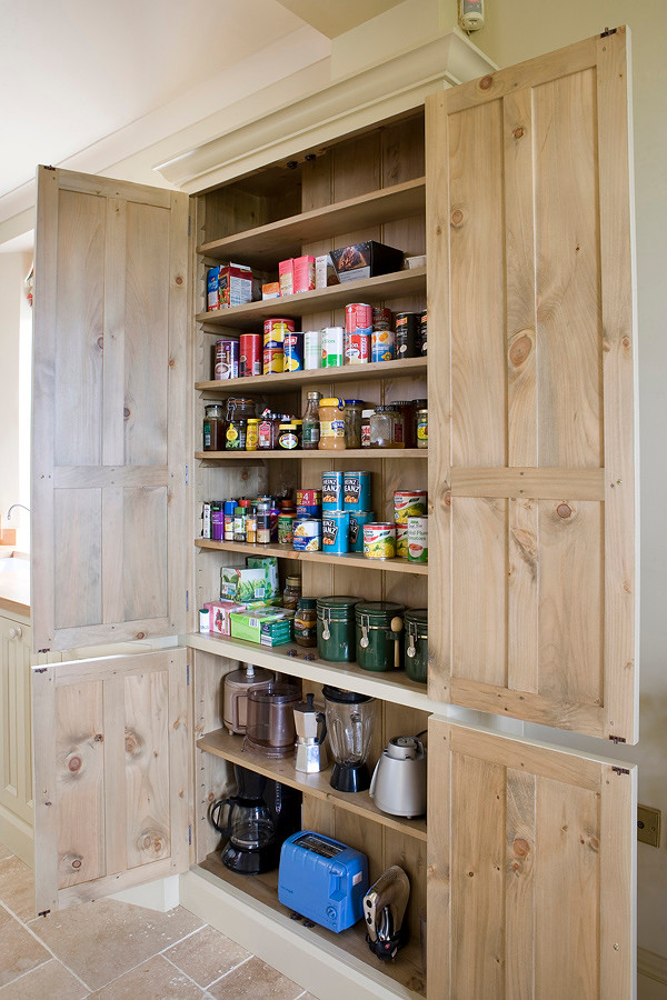 Inspiration for a country kitchen in Other with beaded cabinets and wood worktops.
