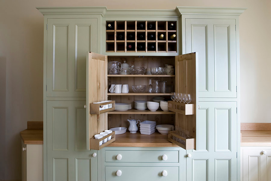 This is an example of a country kitchen in Other with beaded cabinets and wood worktops.