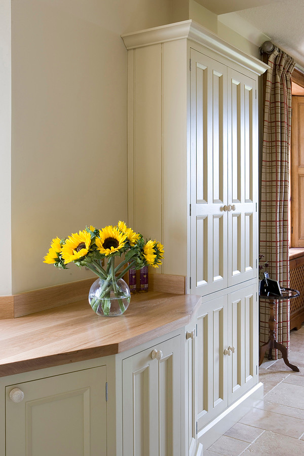 Kitchen - country kitchen idea in Other with beaded inset cabinets and wood countertops