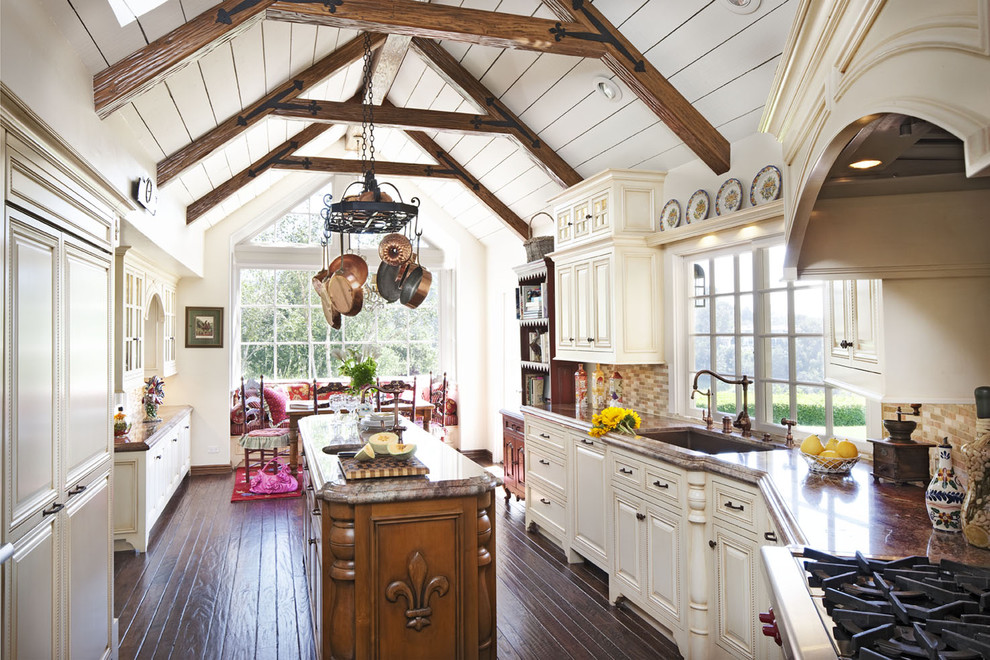 Inspiration for a timeless u-shaped dark wood floor eat-in kitchen remodel in Los Angeles with raised-panel cabinets, beige cabinets, an undermount sink, multicolored backsplash, matchstick tile backsplash, stainless steel appliances and an island