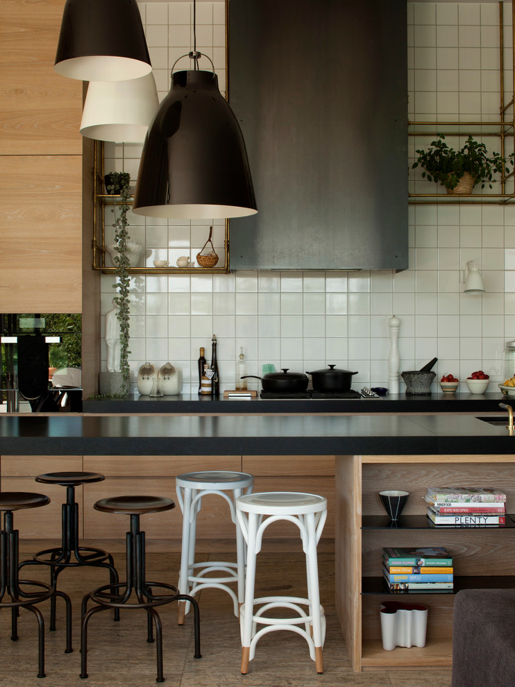 Example of a large galley medium tone wood floor eat-in kitchen design in Auckland with a farmhouse sink, open cabinets, medium tone wood cabinets, marble countertops, white backsplash, black appliances and an island