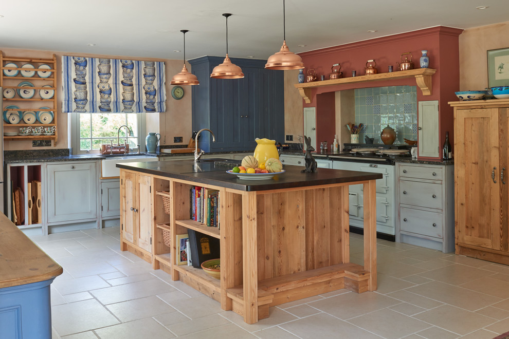Modelo de cocina de estilo de casa de campo con fregadero sobremueble, armarios estilo shaker, puertas de armario azules, salpicadero azul, salpicadero de azulejos de cerámica y electrodomésticos blancos