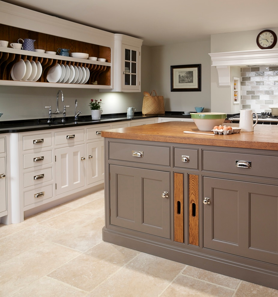 Design ideas for a medium sized rural l-shaped enclosed kitchen in Essex with a submerged sink, shaker cabinets, white cabinets, composite countertops, multi-coloured splashback, ceramic splashback, black appliances, travertine flooring and an island.
