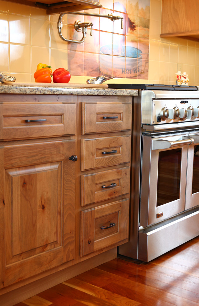 Inspiration for a farmhouse kitchen remodel in Wichita with raised-panel cabinets and light wood cabinets