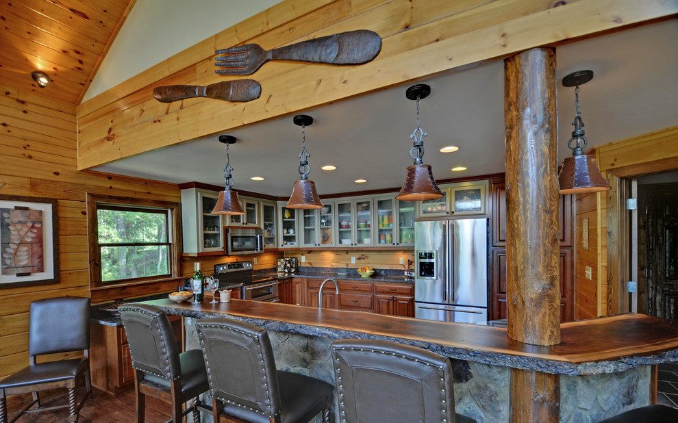 Photo of a rustic kitchen in Atlanta with glass-front cabinets and stainless steel appliances.