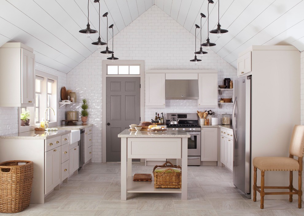 Large country u-shaped eat-in kitchen photo in New York with a farmhouse sink, recessed-panel cabinets, gray cabinets, quartz countertops, white backsplash, subway tile backsplash, stainless steel appliances and an island