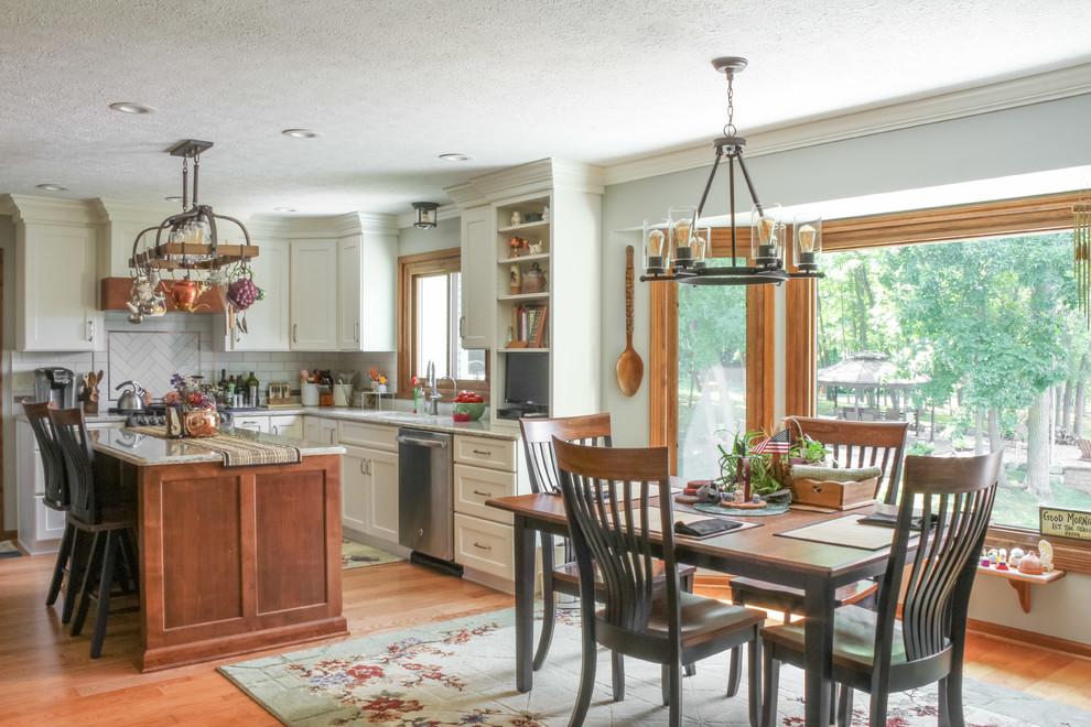 Large country u-shaped light wood floor and brown floor eat-in kitchen photo in Detroit with an undermount sink, shaker cabinets, white cabinets, quartz countertops, white backsplash, subway tile backsplash, stainless steel appliances, an island and beige countertops
