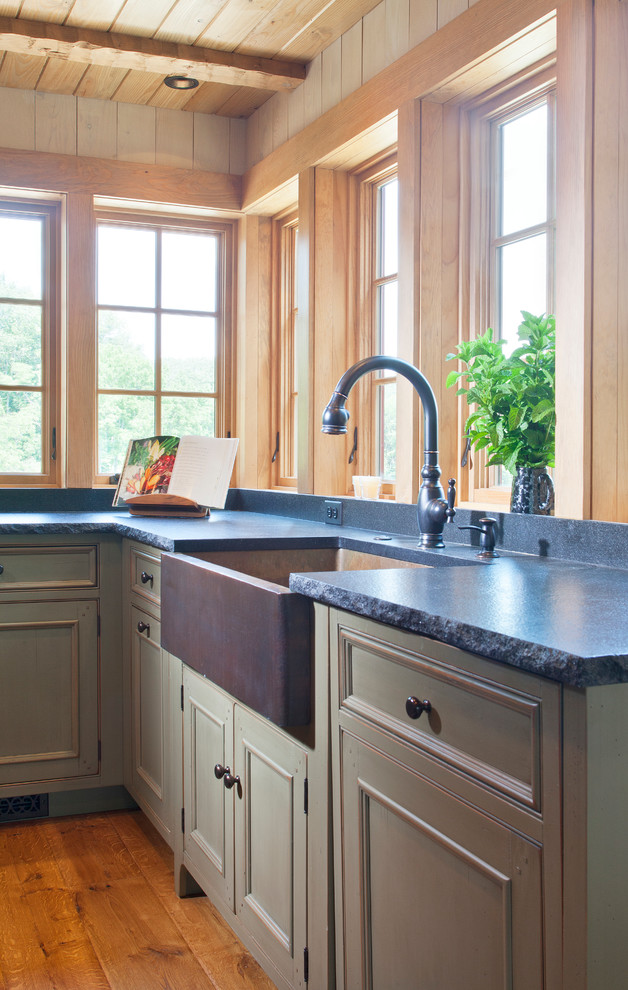 Eat-in kitchen - farmhouse u-shaped eat-in kitchen idea in DC Metro with a farmhouse sink, flat-panel cabinets, wood countertops, black backsplash, stone slab backsplash and stainless steel appliances