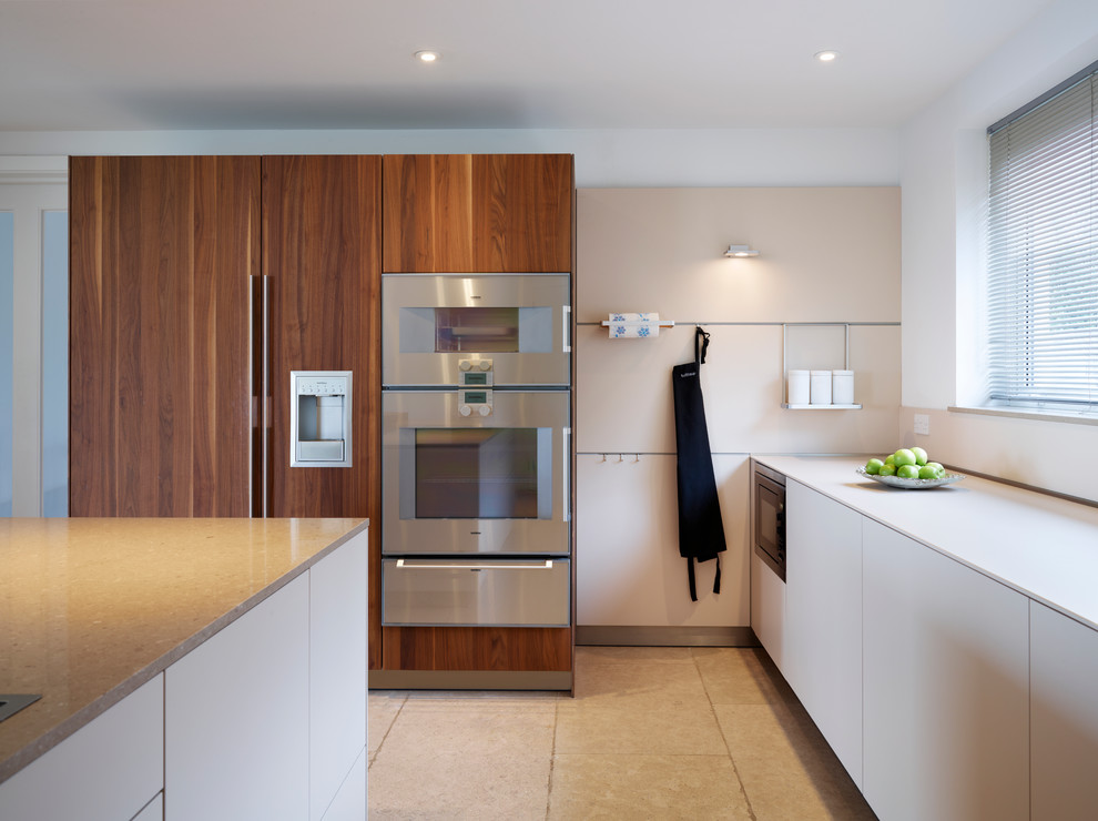 Exempel på ett stort modernt kök med öppen planlösning, med en integrerad diskho, släta luckor, skåp i mellenmörkt trä, bänkskiva i kvartsit, vitt stänkskydd, rostfria vitvaror, klinkergolv i keramik och en köksö
