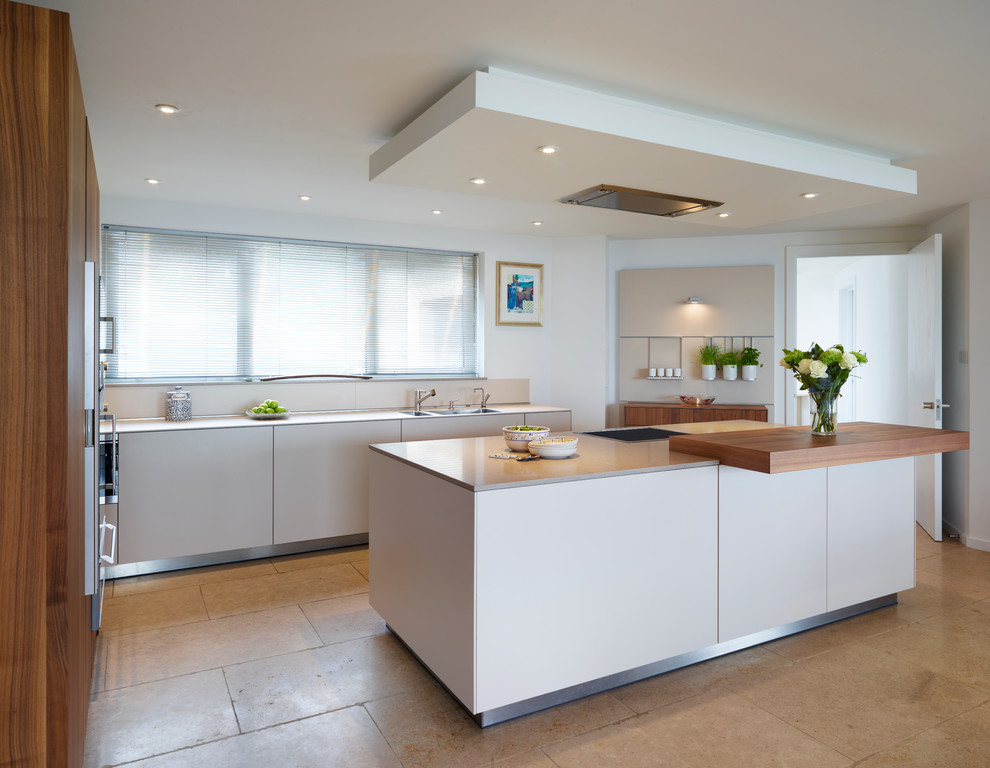 Inspiration for a large contemporary open plan kitchen in Other with an integrated sink, flat-panel cabinets, medium wood cabinets, quartz worktops, white splashback, stainless steel appliances, ceramic flooring and an island.