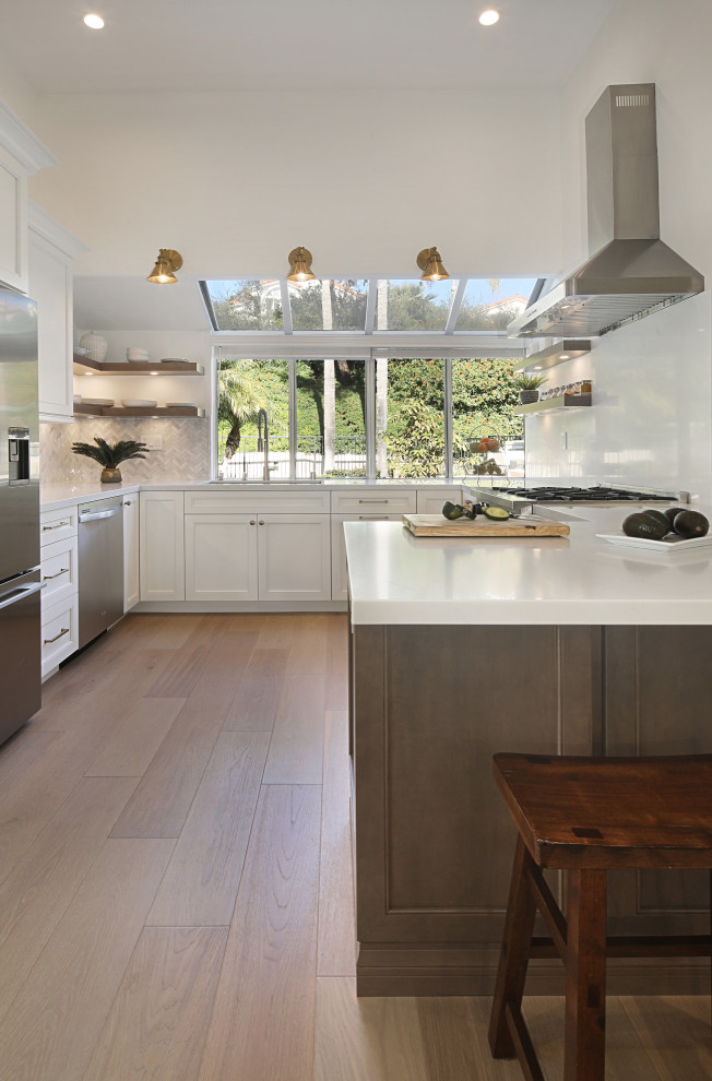 Example of a large trendy u-shaped beige floor eat-in kitchen design in Orange County with an undermount sink, recessed-panel cabinets, white cabinets, quartz countertops, multicolored backsplash, quartz backsplash, stainless steel appliances, a peninsula and yellow countertops