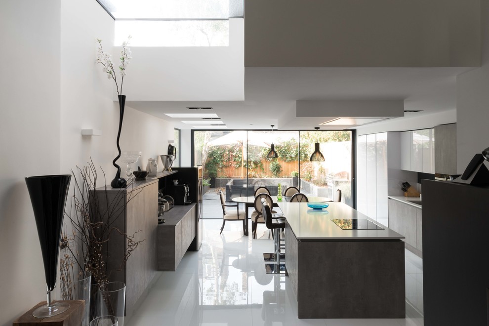 Medium sized contemporary single-wall kitchen/diner in London with porcelain flooring, an island, white floors, flat-panel cabinets and grey cabinets.