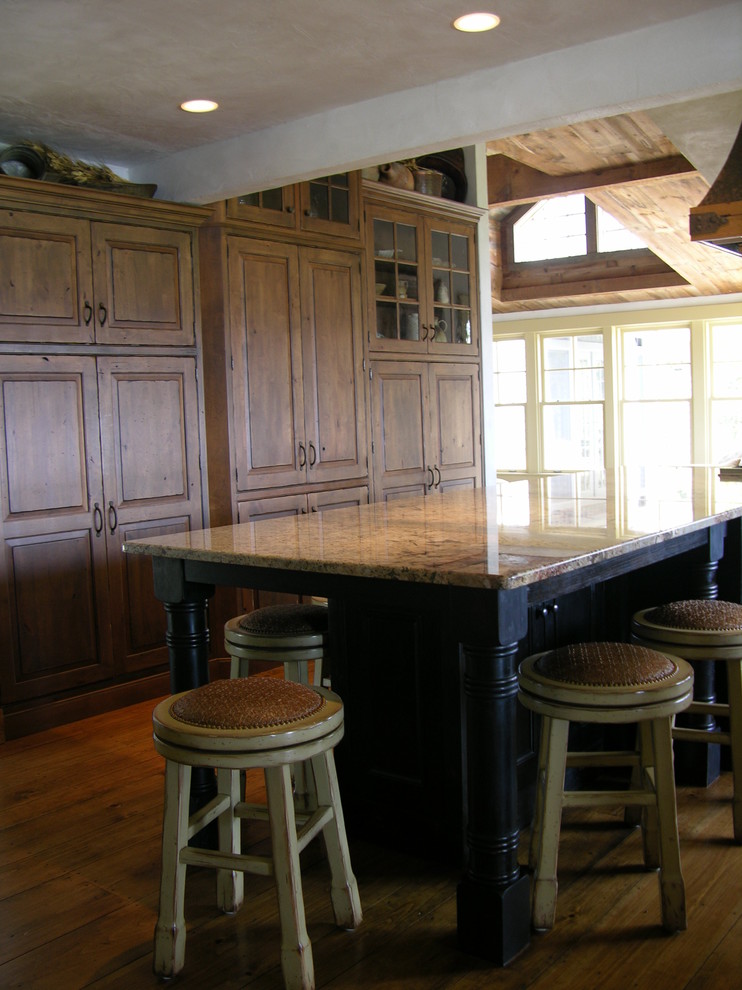 Inspiration for a huge rustic u-shaped medium tone wood floor open concept kitchen remodel in Portland Maine with beaded inset cabinets, dark wood cabinets, granite countertops, paneled appliances and an island