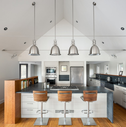 Industrial Chic: Concrete Countertop and White Central Island with Metallic Pendant Lamps