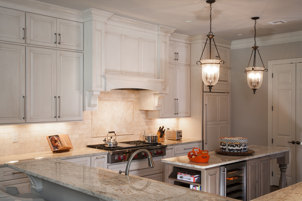 Eat-in kitchen - mid-sized traditional l-shaped medium tone wood floor eat-in kitchen idea in New Orleans with a single-bowl sink, beaded inset cabinets, white cabinets, granite countertops, multicolored backsplash, cement tile backsplash, stainless steel appliances and an island