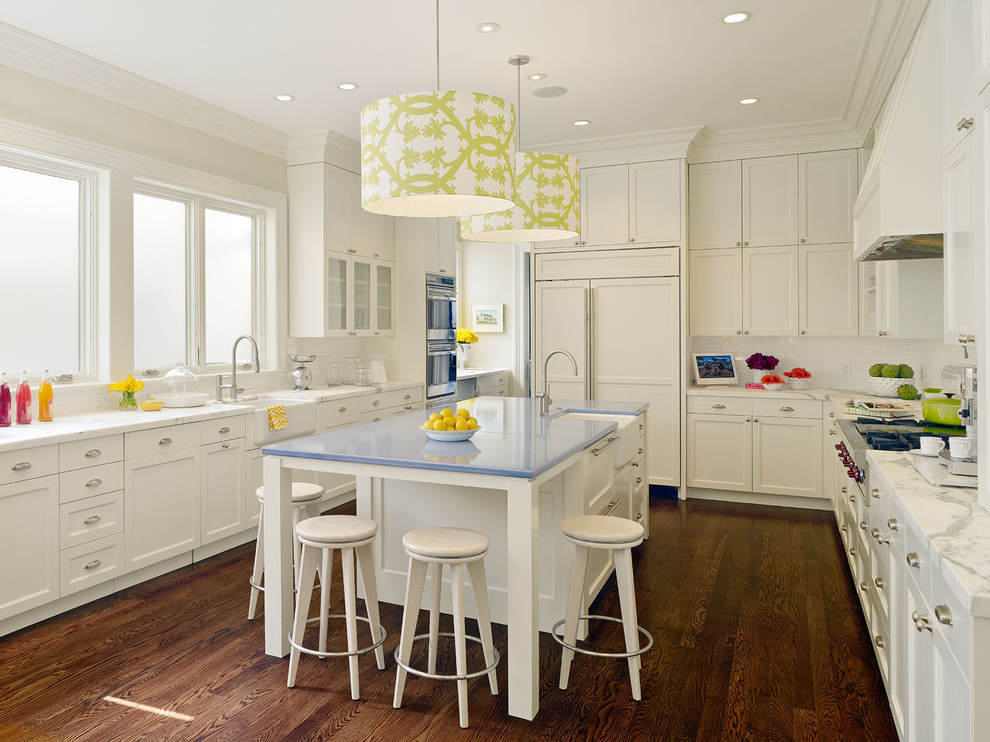 Example of a transitional kitchen design in San Francisco with paneled appliances, a farmhouse sink and blue countertops