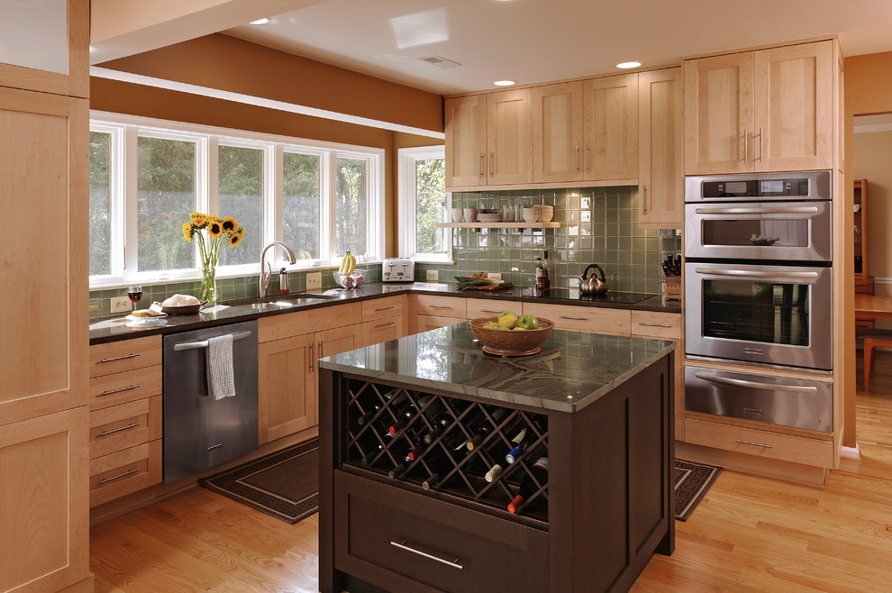 Large transitional l-shaped light wood floor eat-in kitchen photo in DC Metro with an undermount sink, shaker cabinets, light wood cabinets, granite countertops, green backsplash, glass tile backsplash, stainless steel appliances and an island