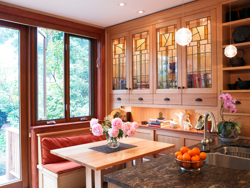 Inspiration for a craftsman kitchen remodel in Toronto with a double-bowl sink, glass-front cabinets and medium tone wood cabinets