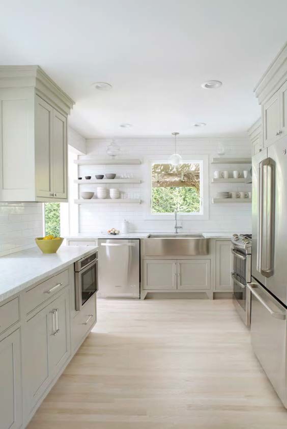 Eat-in kitchen - mid-sized u-shaped light wood floor and yellow floor eat-in kitchen idea in New York with a farmhouse sink, beaded inset cabinets, gray cabinets, marble countertops, white backsplash, subway tile backsplash, stainless steel appliances and no island