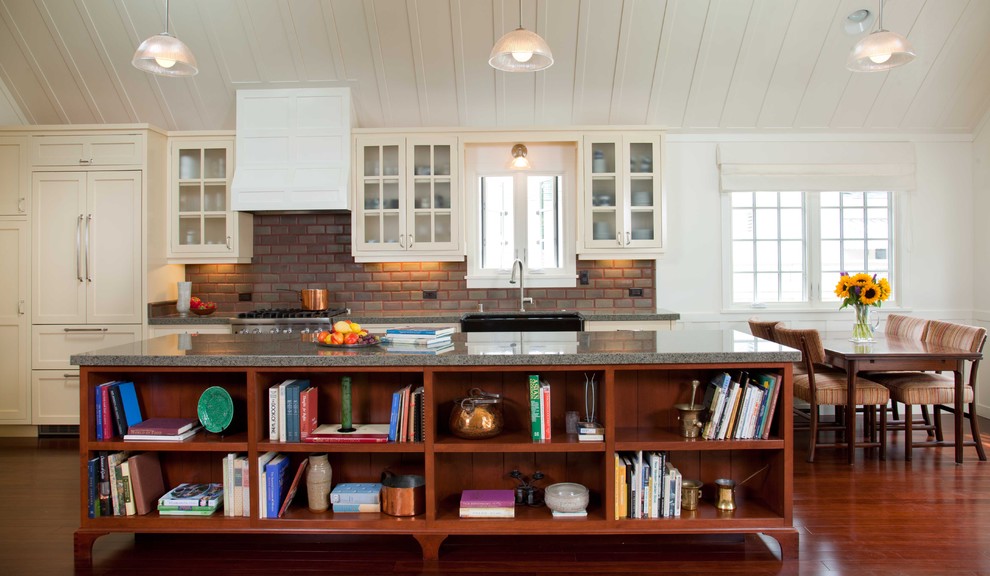 Large elegant single-wall dark wood floor and brown floor eat-in kitchen photo in San Diego with glass-front cabinets, granite countertops, beige cabinets, subway tile backsplash, red backsplash, stainless steel appliances and an island