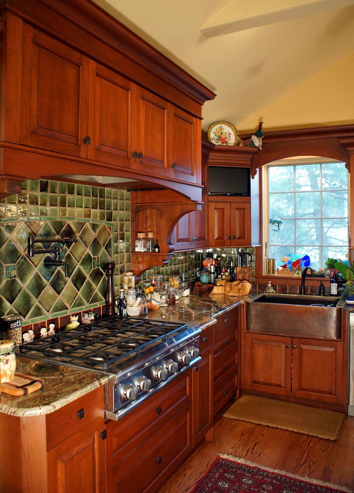 Bild på ett mellanstort vintage kök och matrum, med en köksö, luckor med upphöjd panel, skåp i mellenmörkt trä, granitbänkskiva, grönt stänkskydd, stänkskydd i keramik, rostfria vitvaror, en rustik diskho och mellanmörkt trägolv