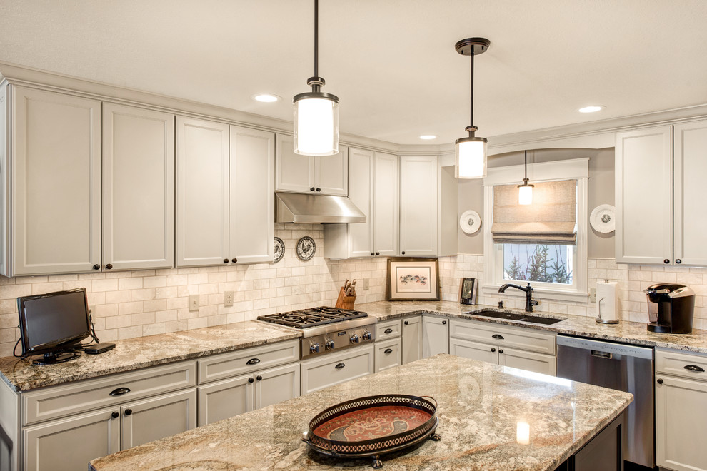 Medium sized traditional u-shaped kitchen/diner in Minneapolis with a submerged sink, recessed-panel cabinets, grey cabinets, granite worktops, white splashback, stone tiled splashback, stainless steel appliances, medium hardwood flooring and an island.