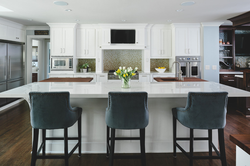 Transitional dark wood floor kitchen photo in Atlanta with an integrated sink, shaker cabinets, white cabinets, beige backsplash, mosaic tile backsplash, stainless steel appliances and two islands