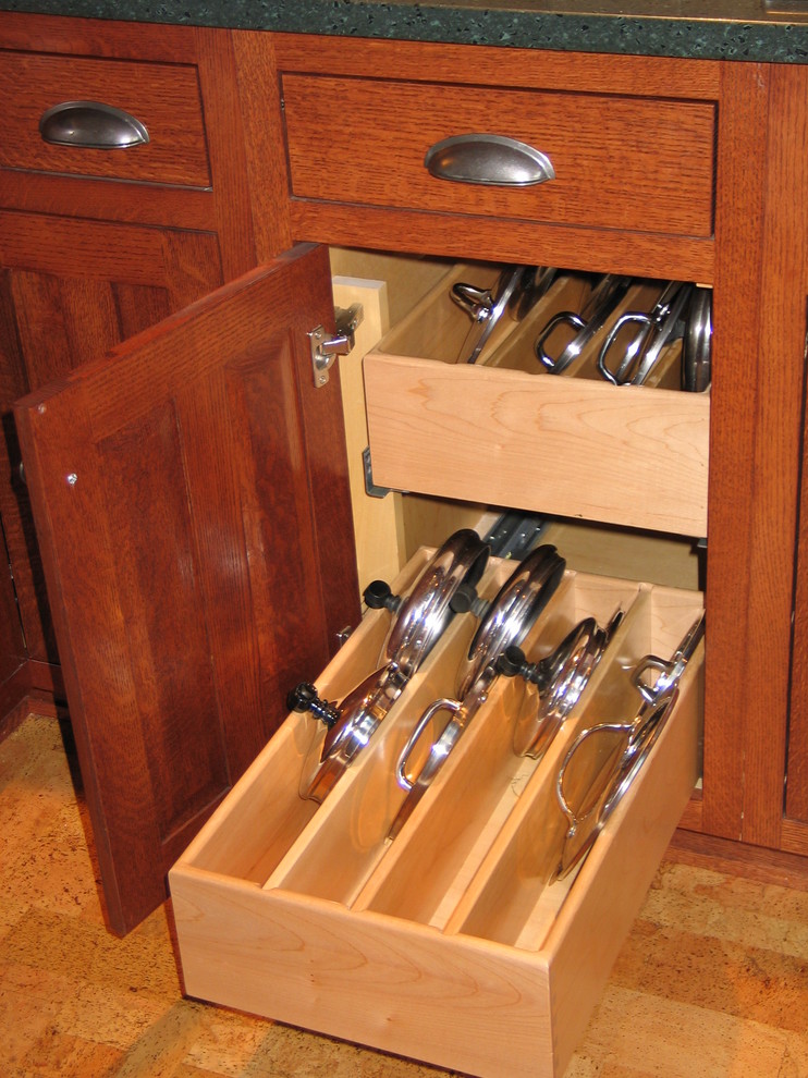 Inspiration for a medium sized classic u-shaped enclosed kitchen in Chicago with a submerged sink, shaker cabinets, medium wood cabinets, stainless steel appliances and cork flooring.