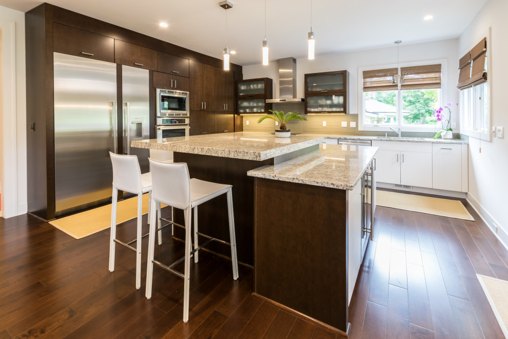 Kitchen - contemporary l-shaped medium tone wood floor and brown floor kitchen idea in Detroit with an undermount sink, flat-panel cabinets, medium tone wood cabinets, gray backsplash, glass tile backsplash, stainless steel appliances, an island and beige countertops