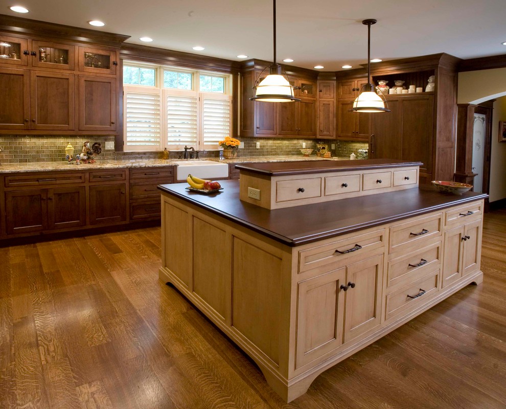 Inspiration for a large traditional u-shaped kitchen/diner in Other with a belfast sink, recessed-panel cabinets, dark wood cabinets, ceramic splashback, integrated appliances, medium hardwood flooring and an island.