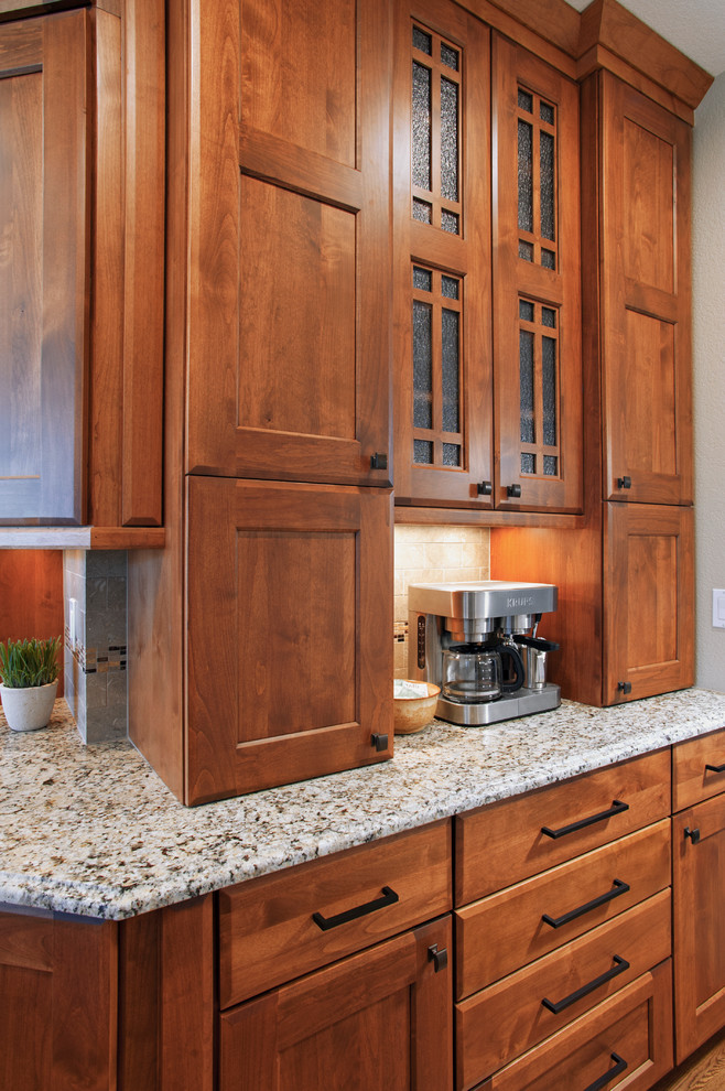 Example of an arts and crafts kitchen design in Denver with flat-panel cabinets and brown cabinets