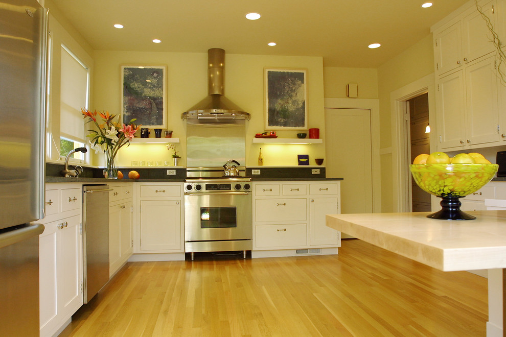 This is an example of a contemporary kitchen in San Francisco with stainless steel appliances and limestone worktops.