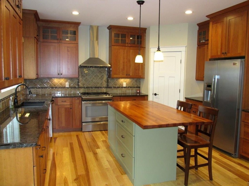 Kitchen pantry - mid-sized craftsman u-shaped light wood floor kitchen pantry idea in New York with an integrated sink, shaker cabinets, medium tone wood cabinets, wood countertops, multicolored backsplash, cement tile backsplash, stainless steel appliances and an island