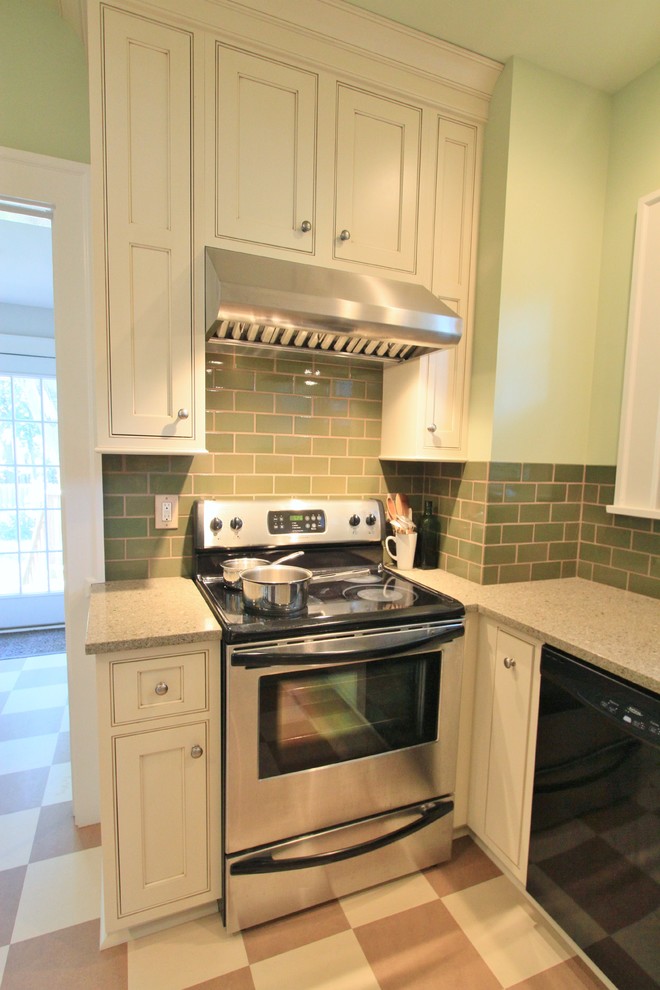 Photo of a small classic u-shaped enclosed kitchen in Other with a single-bowl sink, beaded cabinets, white cabinets, green splashback, stainless steel appliances, lino flooring, no island and recycled glass countertops.