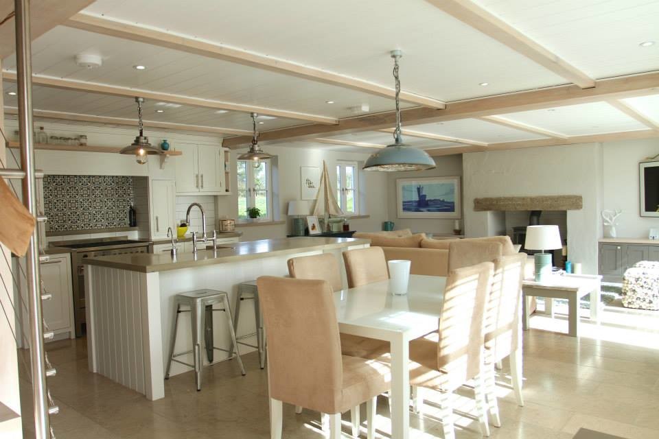 Eat-in kitchen - large coastal single-wall eat-in kitchen idea in Surrey with beaded inset cabinets, beige cabinets, wood countertops and an island