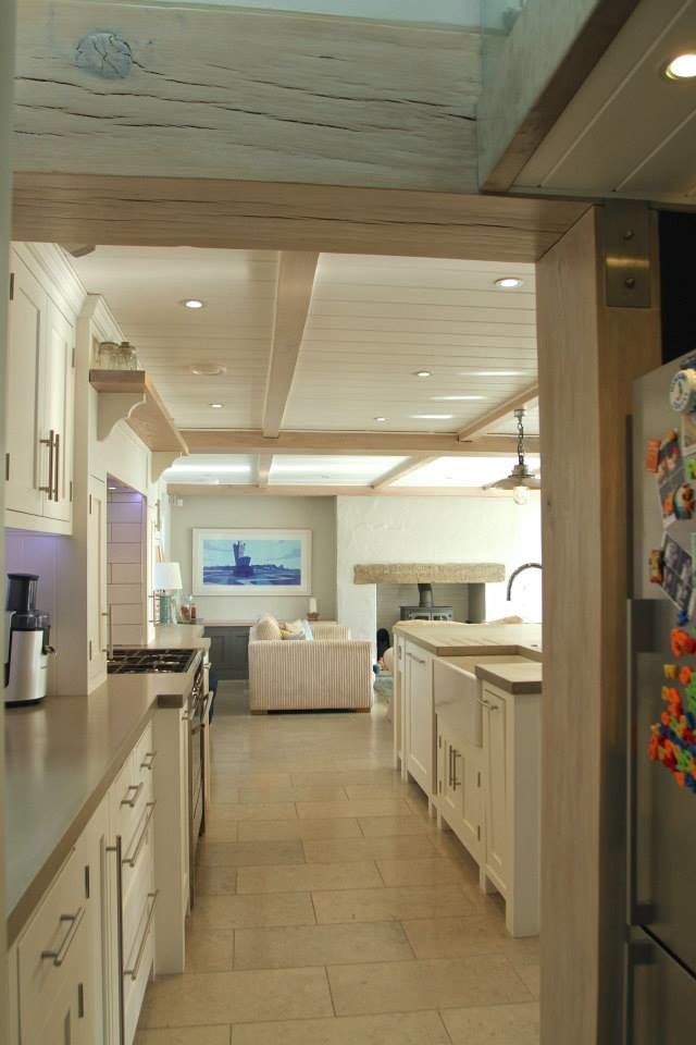 Design ideas for a large beach style single-wall kitchen/diner in Surrey with beaded cabinets, beige cabinets, wood worktops and an island.