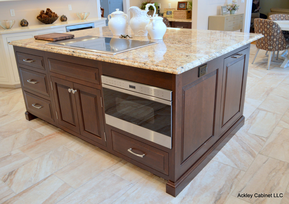 Example of a large classic l-shaped limestone floor eat-in kitchen design in New York with an undermount sink, raised-panel cabinets, white cabinets, granite countertops, brown backsplash, matchstick tile backsplash, stainless steel appliances and an island