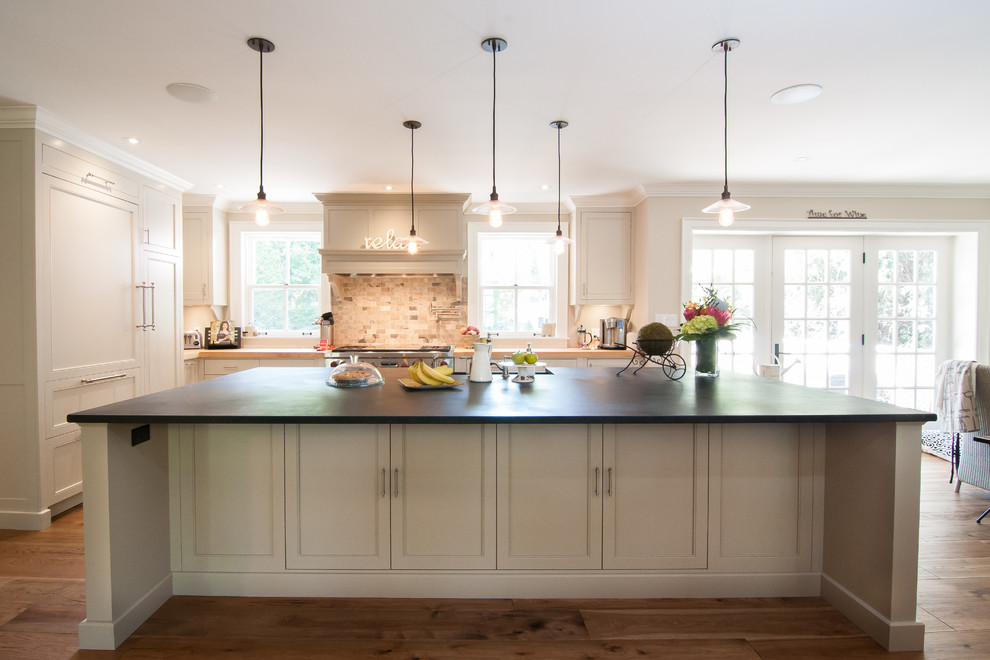 Inspiration for a large farmhouse galley eat-in kitchen remodel in Toronto with white cabinets and an island