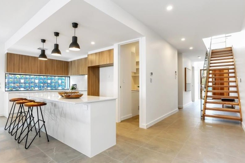 Photo of a large contemporary l-shaped open plan kitchen in Adelaide with quartz worktops, white splashback, ceramic splashback, porcelain flooring, an island and brown floors.