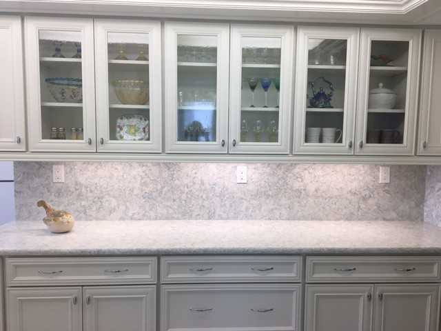 Example of a mid-sized beach style kitchen design in Miami with white cabinets, quartz countertops, stone slab backsplash, white appliances and recessed-panel cabinets