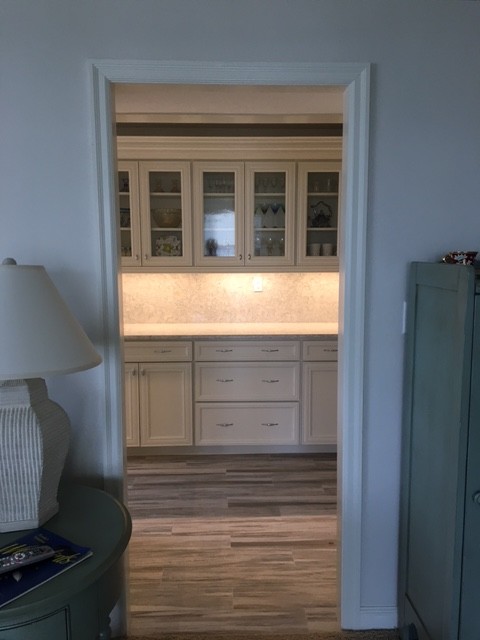 Mid-sized beach style porcelain tile kitchen photo in Miami with recessed-panel cabinets, white cabinets, stone slab backsplash, white appliances, an undermount sink and quartz countertops