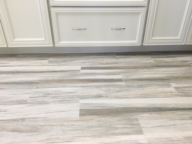 Inspiration for a mid-sized coastal kitchen remodel in Miami with recessed-panel cabinets, white cabinets, white appliances, quartz countertops and stone slab backsplash